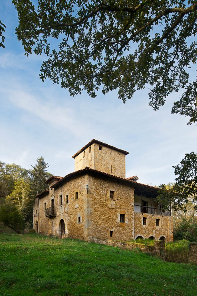 Historic stone palace among Asturian woodland