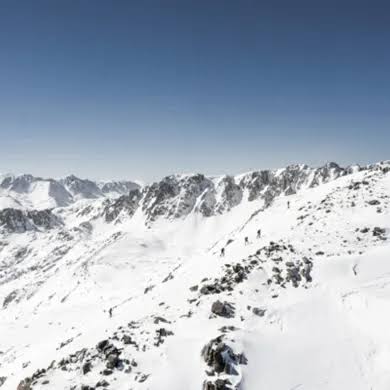 Snow-covered Pyrenean ridgelines under a clear winter sky