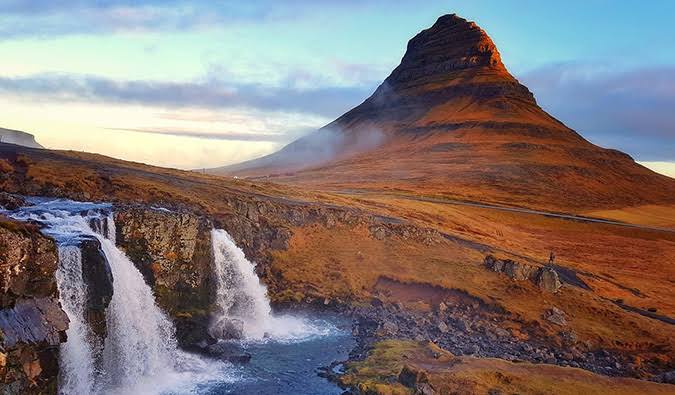 Waterfalls below Kirkjufell mountain at sunrise in west Iceland
