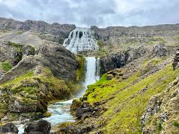 Tiered Dynjandi waterfall spilling down a mossy Icelandic mountainside