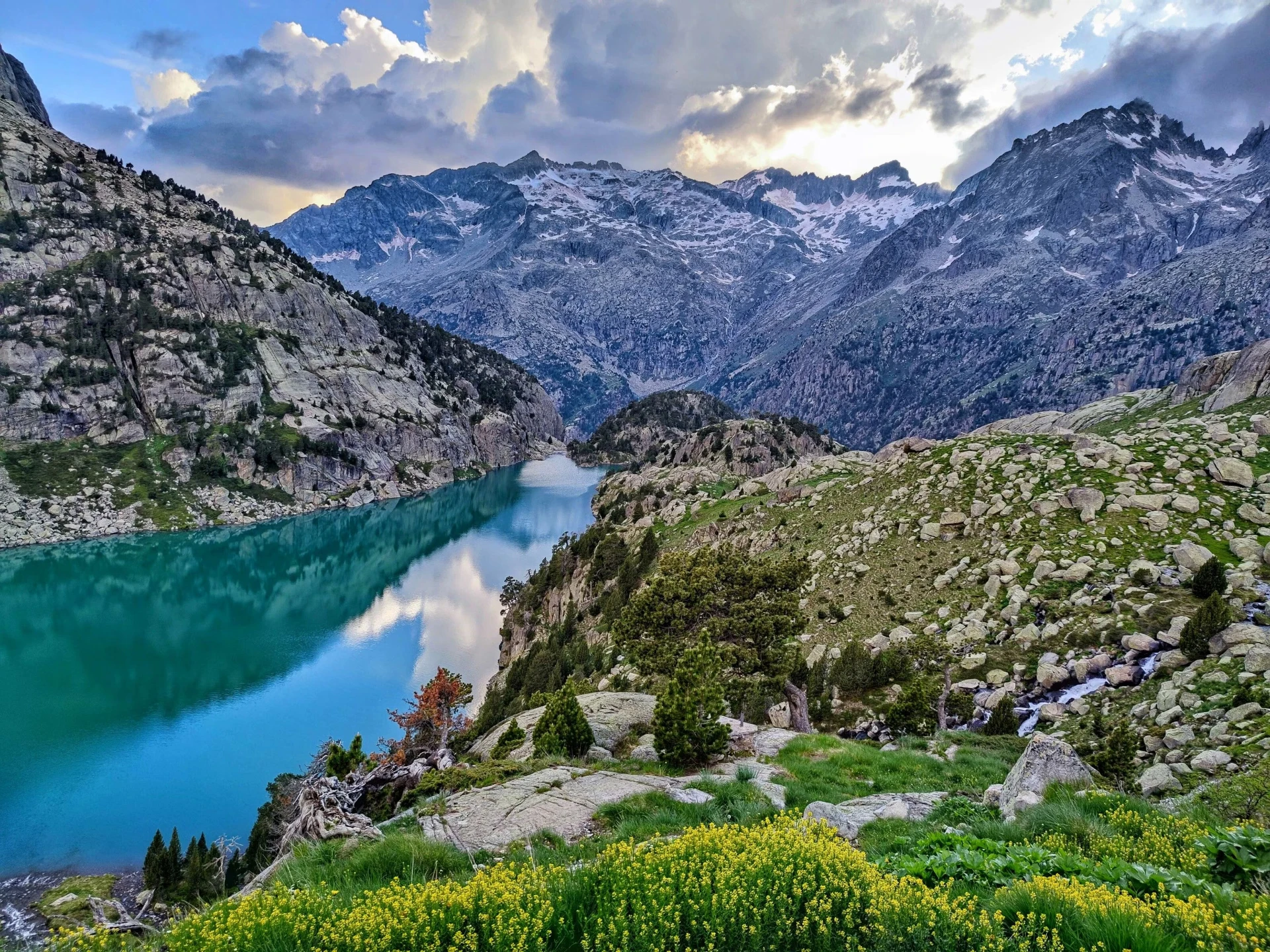 Turquoise glacial lake beneath granite peaks in the Pyrenees